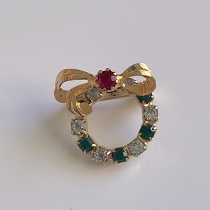 Holiday Wreath Brooch in gold color with red, green and clear gemstones.